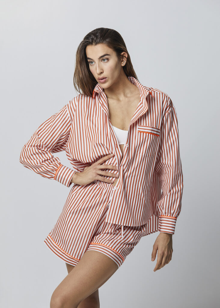 Modella indossa Camicia oversize e shorts a righe arancio